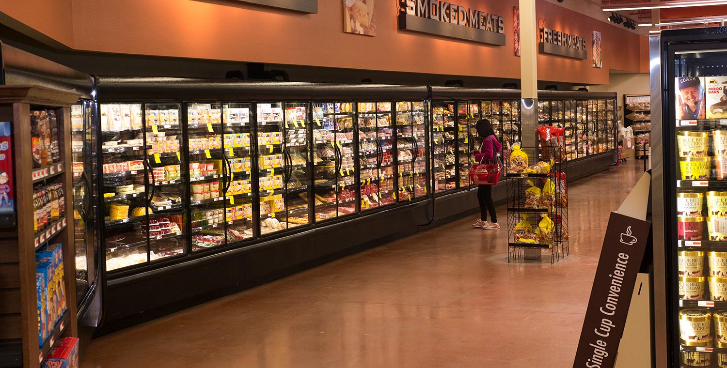 Shopper in the cheese and smoked meats aisle